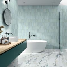 a modern bathroom with green and white tiles on the walls, flooring and bathtub