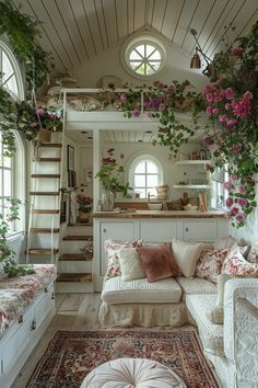 a living room filled with lots of furniture and flowers on the wall next to stairs