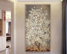 a large painting hanging on the wall in a living room next to a door way