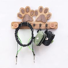 the leash holder is made out of wood and has paw prints on it