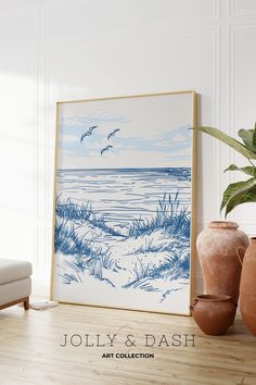 a blue and white painting sitting on top of a wooden floor next to vases