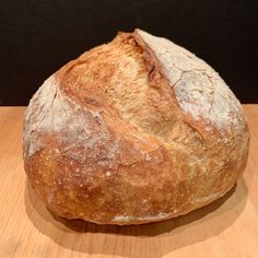 a loaf of bread sitting on top of a wooden table