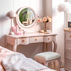 a bedroom with a dresser, mirror and stool