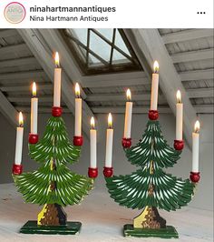 there are many lit candles in the shape of christmas trees