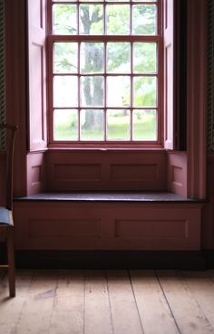 an empty bench in front of a window