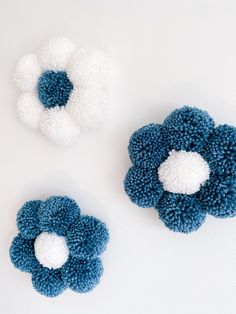 three pieces of blue and white crocheted hair accessories