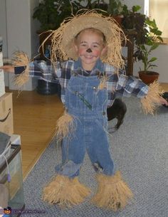 a young boy dressed up as a scarecrow