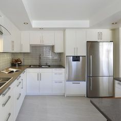 a kitchen with stainless steel appliances and white cabinets