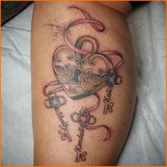 a tattoo on the leg of a woman with a heart and key in it's center