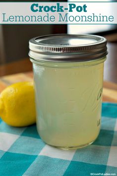 a mason jar filled with lemonade sitting on top of a blue and white checkered table cloth