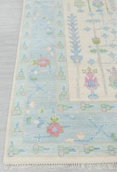 a blue and white rug with flowers on it