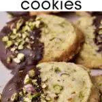 cookies with chocolate and pistachio toppings are on a white plate next to other cookies