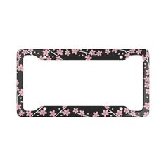 a black and pink flowered license plate frame with white flowers on the bottom half