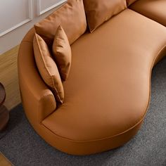 a brown leather couch sitting on top of a carpeted floor