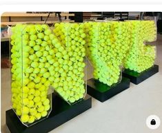 three large display cases filled with tennis balls