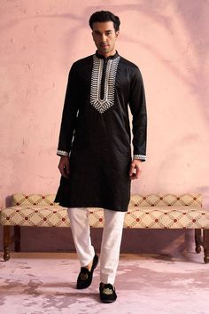 SHRESTHA BY VASTRAMAY Men's Black Silk Machine Embroidered Kurta Elegant and trendy, this black kurta features machine embroidery on the neckline. Made from a silk blend, it has a mandarin collar, long sleeves, and side slits for added comfort. Key Features Black silk blend with machine embroidery Mandarin collar Long sleeves Side slits Specifications Knee length Material & Care Top fabric: Silk blend Dry clean only Legal Disclaimer: The product is guaranteed to be 100% genuine. Product images a Black Long Sleeve Kurta For Festive Occasions, Casual Black Festive Kurta, Black Long Sleeve Festive Kurta, Traditional Black Long Sleeve Kurta, Black Long Sleeve Kurta With Chikankari Embroidery, Black Cotton Traditional Wear With Long Sleeves, Black Cotton Long Sleeve Traditional Wear, Black Long Sleeve Traditional Cotton Wear, Traditional Black Embroidered Kurta