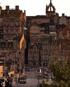 an old city street with cars parked on both sides