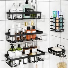 two black shelves with soaps, lotions and other items on them in a white tiled bathroom