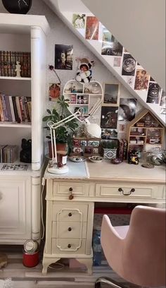 a room with a desk, chair and bookshelf on the top of it