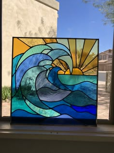 a stained glass window with a wave in it