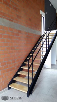 a set of stairs in front of a brick wall