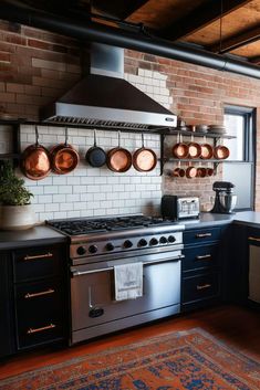 a kitchen with pots and pans hanging on the wall above an oven, stove top and sink