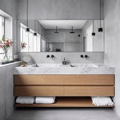 a bathroom with two sinks and mirrors in it