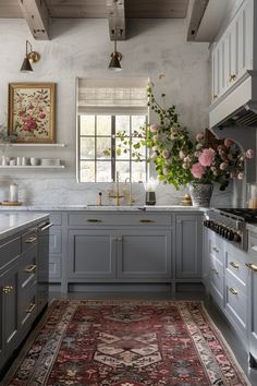 a kitchen with gray cabinets and rug in the middle