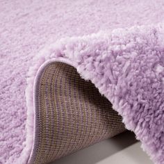 a close up view of a purple rug on the floor with it's edge