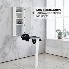 an easy installation hardware fittings included in a white cabinet with marbled wallpaper