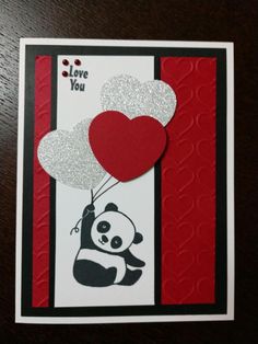 a card with a panda holding a heart shaped balloon