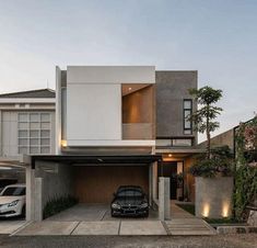 a car is parked in front of a modern house