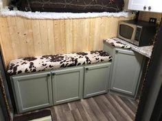 a kitchen area with a microwave and cabinets