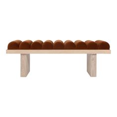 a bench made out of wood and brown velvet cushions on it's back legs