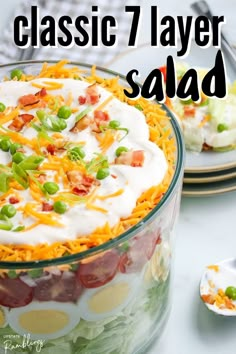 a close up of a salad in a bowl with the words classic 7 layer salad