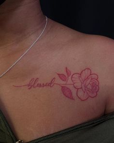 a woman's chest with a tattoo that says, loved on it and a flower