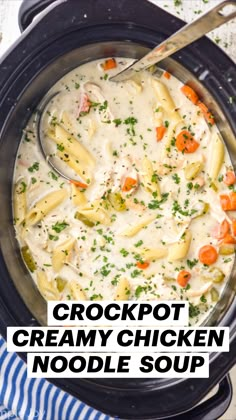 a crock pot filled with chicken noodle soup on top of a blue and white towel