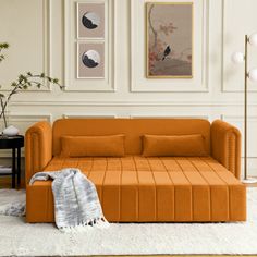 an orange couch sitting on top of a white rug