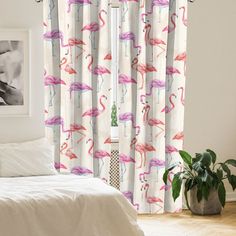 a bedroom with pink flamingos on the curtains