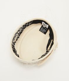 a white bowl with black and white designs on it's sides, sitting on a white surface