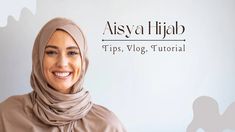 a woman wearing a headscarf smiles at the camera while standing in front of a white wall