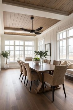 a dining room table with chairs and a ceiling fan