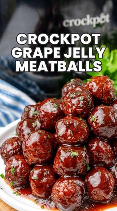 crockpot grape jelly meatballs on a white plate with lettuce in the background