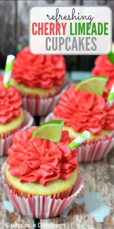 cupcakes with red frosting and lime on top are sitting on a table