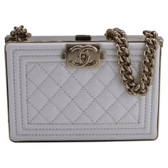 Elevate Your Evening Ensemble With The Chanel Quilted Boy Chain Box Minaudiere, A Luxurious Piece Crafted From White Patent Leather Adorned With The Iconic Quilted Cowhide Pattern. Complete With Gold-Tone Metal Hardware, Interior Mirror, Card Slot, And A Push-Button Clasp, This Exquisite Minaudiere Exudes Sophistication And Charm For Any Special Occasion. With Box, Dust Bag Chanel Quilted Boy Chain Box Minaudiere In White Patent Leather Condition: Very Good Signs Of Wear: No Retail Tag, No Visib Cowhide Pattern, Interior Mirror, Bag Chanel, Mirror Interior, Metal Hardware, Push Button, Gold Tone Metal, Chanel Bag, Leather Women