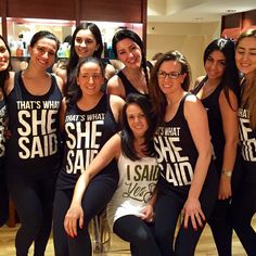 a group of women in matching shirts posing for a photo with one woman on her knees