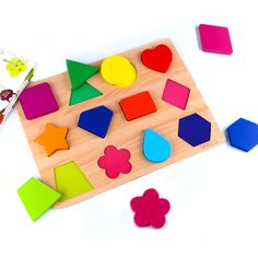 a wooden puzzle with different shapes and colors