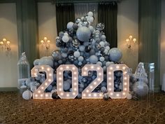 a large balloon tree with the number 20 on it's base and balloons around it