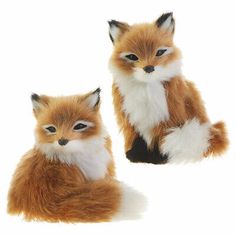 two small stuffed foxes sitting next to each other