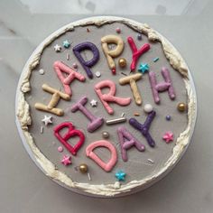 a birthday cake with the words happy birthday spelled out in icing and stars on top